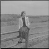Unidentified woman on fence