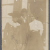 Two women standing with man, close up