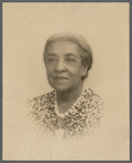 Studio portrait of Sarah Myers Blackwell in pearls and print dress