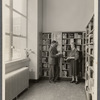 John in library holding book