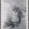 Woman standing over person at beach