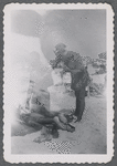 Woman standing over person at beach