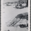 Woman lying on stomach on beach blanket