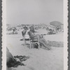 Two women seated at beach