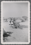 Two women seated at beach