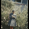 Jeanie standing in front of bushes