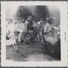 Man in folding chair at outdoor gathering