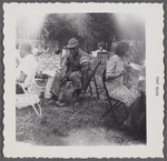 Man in folding chair at outdoor gathering