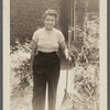 Jean Blackwell Hutson holding rake in garden