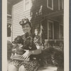 Jean Blackwell Hutson on front stoop with two dogs in her lap