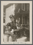 Jean Blackwell Hutson on front stoop with two dogs in her lap