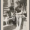 Jean Blackwell Hutson on front stoop with two dogs on steps