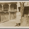 Older woman standing by tree