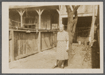 Older woman standing by tree