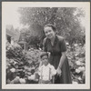 Jean Blackwell Hutson with boy in flower garden