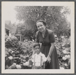 Jean Blackwell Hutson with boy in flower garden