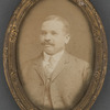 Framed photo of mustachioed man in suit