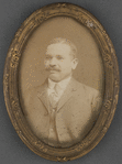 Framed photo of mustachioed man in suit