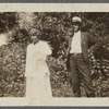 Older couple in front of shrubbery