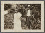 Older couple in front of shrubbery