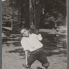 Boy in rolled-up pants holding baseball glove