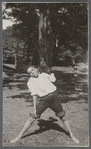 Boy in rolled-up pants holding baseball glove