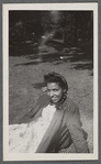 Woman in braids and cardigan