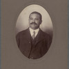 Man with mustache in three-piece suit