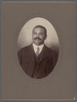 Man with mustache in three-piece suit