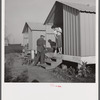 Camp member on porch of her shelter at Osceola migratory labor camp. Belle Glade, Florida