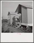Camp member on porch of her shelter at Osceola migratory labor camp. Belle Glade, Florida