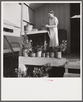 Camp member on porch of her shelter at Osceola migratory labor camp. Belle Glade, Florida