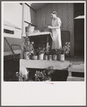 Camp member on porch of her shelter at Osceola migratory labor camp. Belle Glade, Florida
