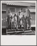 The Robinson family outside their shelter at Okeechobee migratory labor camp. Belle Glade, Florida
