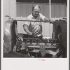 Camp member repairing his car outside his shelter. Osceola migratory labor camp. Belle Glade, Florida