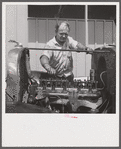 Camp member repairing his car outside his shelter. Osceola migratory labor camp. Belle Glade, Florida