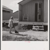 Camp members' children are taking an interest in keeping shelters and grounds clean. Osceola migratory labor camp. Belle Glade, Florida