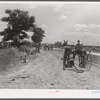 Cultivators and teams leaving central barn at one o'clock to complete their field work during the afternoon. Terrebonne Project, Schriever, Louisiana