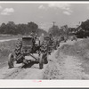 Tractors going to cultivate the sugarcane fields at one o'clock. Terrebonne Project, Schriever, Louisiana