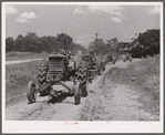 Tractors going to cultivate the sugarcane fields at one o'clock. Terrebonne Project, Schriever, Louisiana