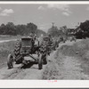 Tractors going to cultivate the sugarcane fields at one o'clock. Terrebonne Project, Schriever, Louisiana