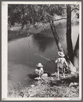 Cajun children fishing in bayou near the school by Terrebonne Project. Schriever, Louisiana