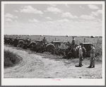 Tractors in the sugarcane fields, with the farm supervisor discussing the problem of cultivation after excessive rains with the foreman, who was chosen from among their own group by the members of the cooperative. Terrebonne Project, Schriever, Louisiana