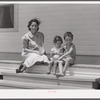 Wife and children of one of the cooperative's members on steps of their home. Terrebonne Project, Schriever, Louisiana