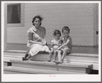 Wife and children of one of the cooperative's members on steps of their home. Terrebonne Project, Schriever, Louisiana