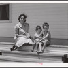 Wife and children of one of the cooperative's members on steps of their home. Terrebonne Project, Schriever, Louisiana