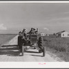 Tractor pulling wagon along project road. Terrebonne Project, Schriever, Louisiana