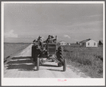 Tractor pulling wagon along project road. Terrebonne Project, Schriever, Louisiana