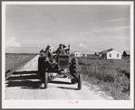 Tractor pulling wagon along project road. Terrebonne Project, Schriever, Louisiana