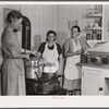 Mrs. Ruth Lina, home management supervisor, helping some of the project women can milk. Terrebonne Project, Schriever, Louisiana